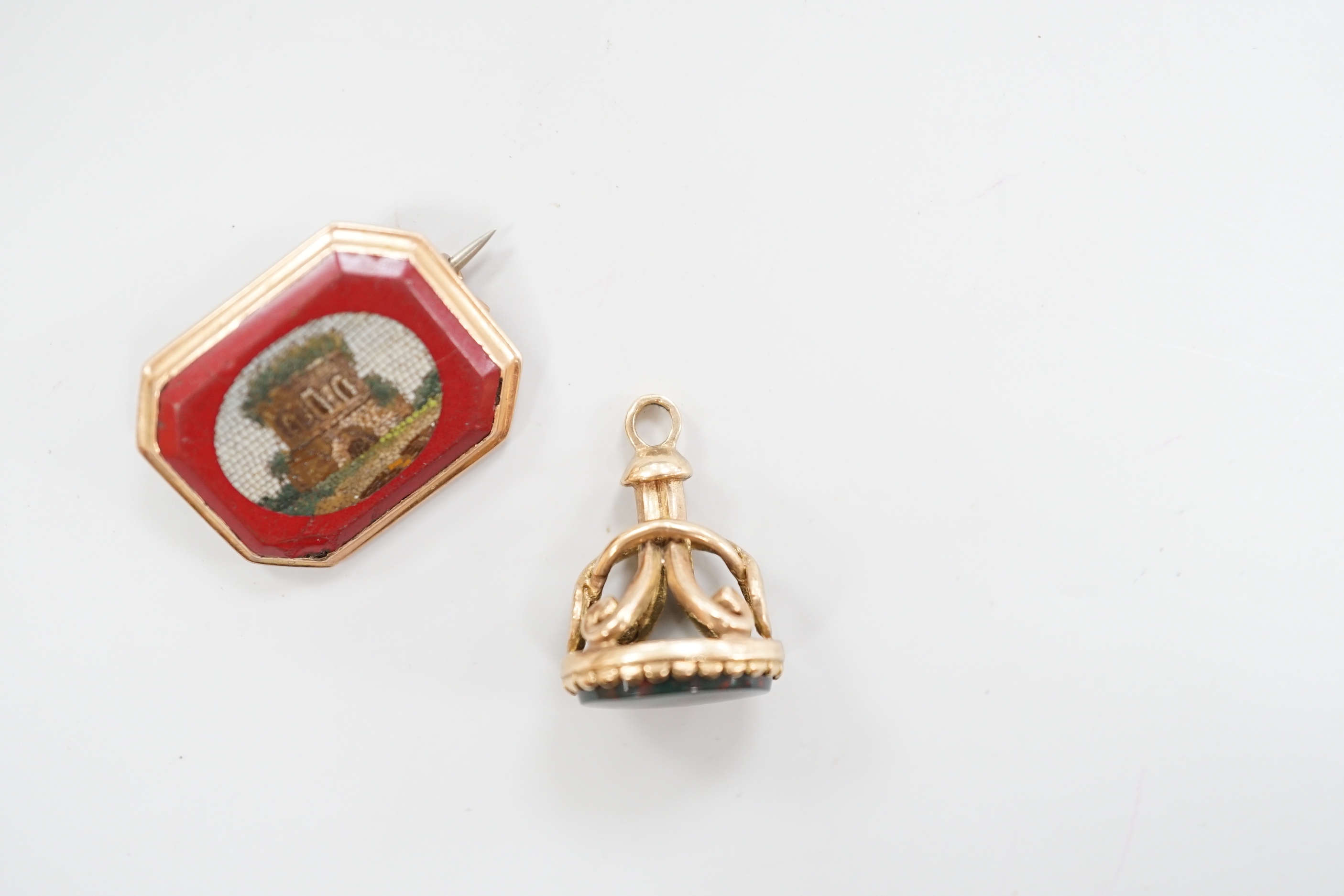 A 19th century yellow metal and micro mosaic set brooch, 23mm and a similar yellow metal overlaid and bloodstone set fob seal.